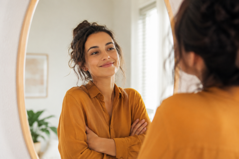 Woman looking positively at her reflection